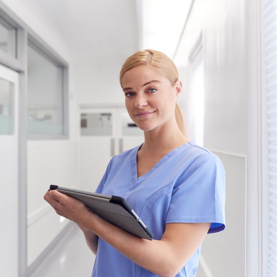 portrait-of-smiling-female-doctor-wearing-scrubs-EYSJKTB-1.jpg